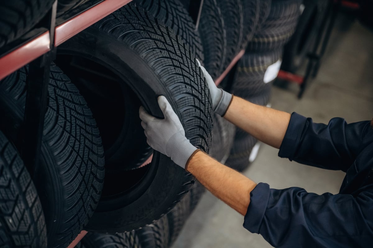Worker taking a tire down at the maintenance station
